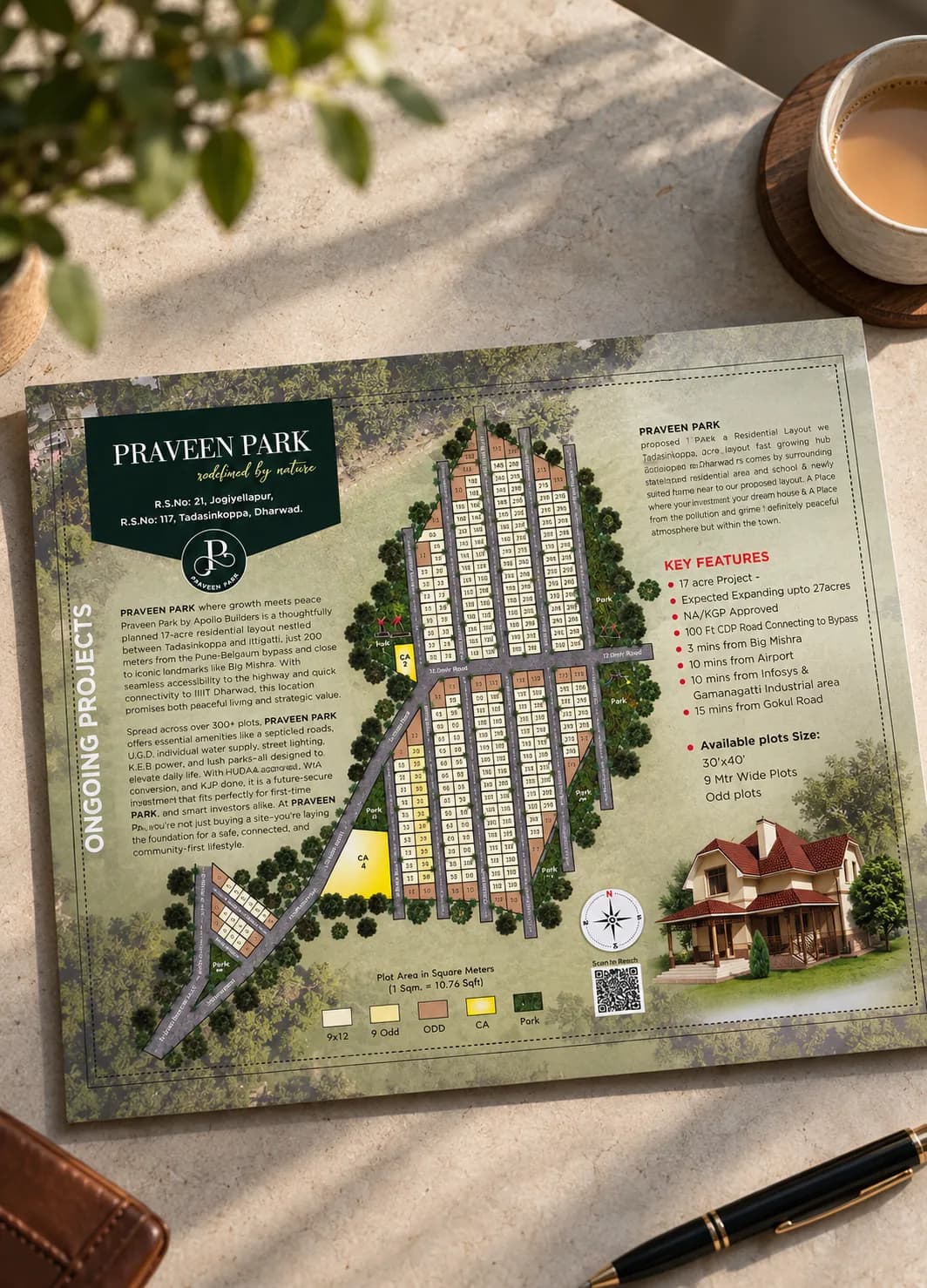 Praveen Park plot layout brochure, Dharwad, laid out on a table